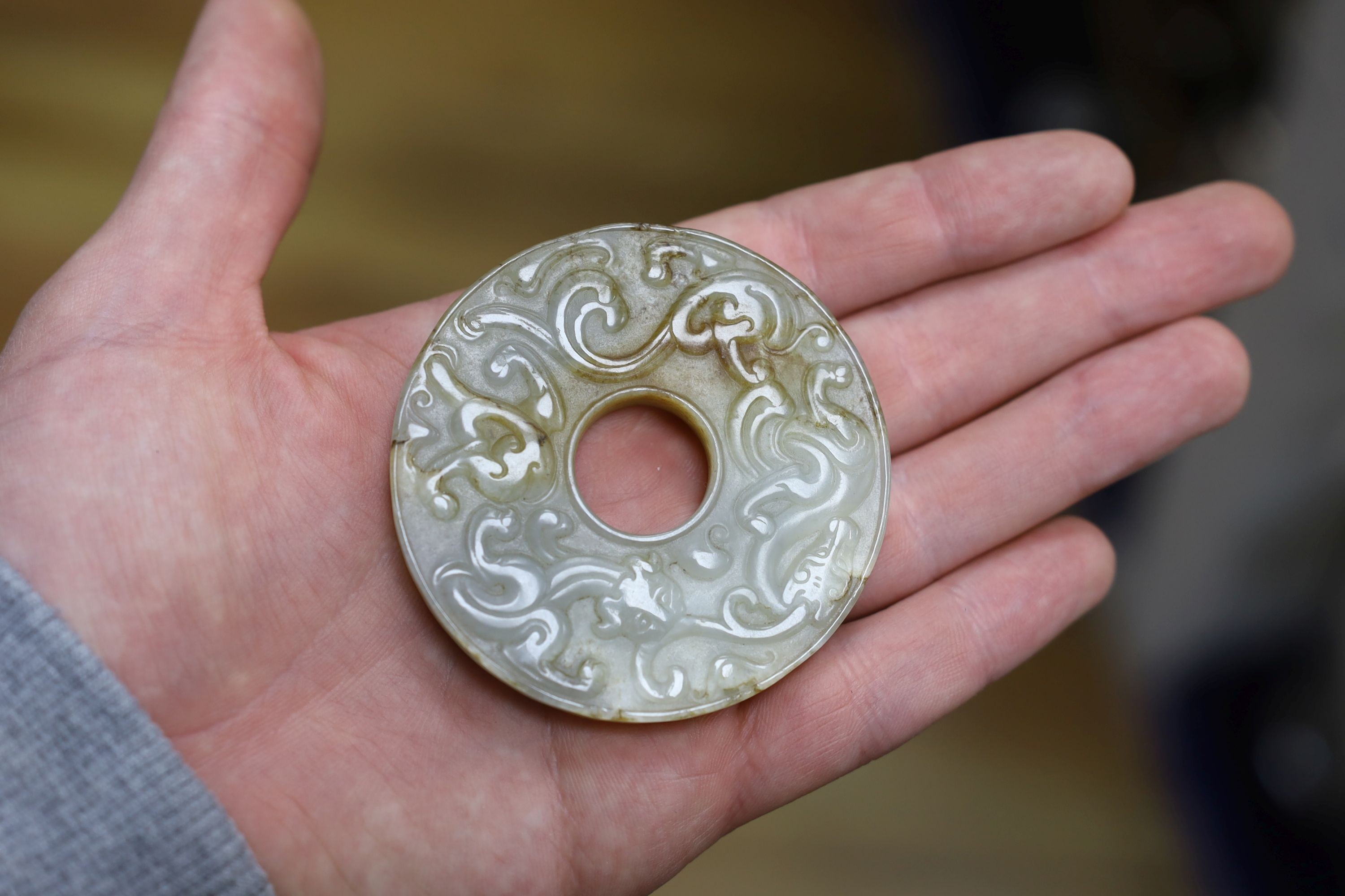 A Chinese white and brown jade bi disc, a Japanese bronze mount and a Chinese archaistic bronze vessel